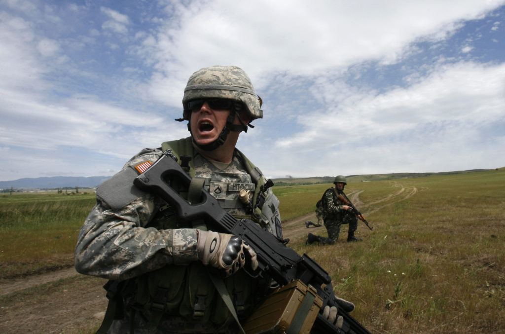 A U.S. military instructor (L) leads during a NATO exercise named &quot;Cooperative Lancer 09&quot; at Vaziani military base outside Tbilisi May 25, 2009. REUTERS/David Mdzinarishvili (GEORGIA POLITICS MILITARY IMAGES OF THE DAY) - RTXN9GJ