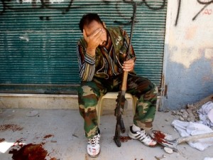 A Free Syrian Army fighter reacts after his friend was shot by Syrian Army soldiers during clashes in the Salah al-Din neighbourhood in central Aleppo